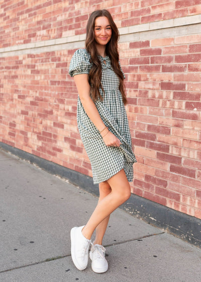 Side view of the sage gingham bow dress