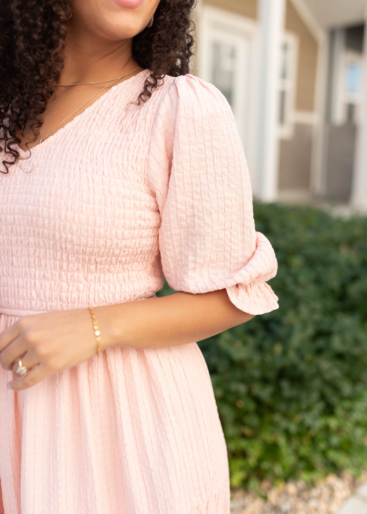 Close up of the modest blush smocked dress