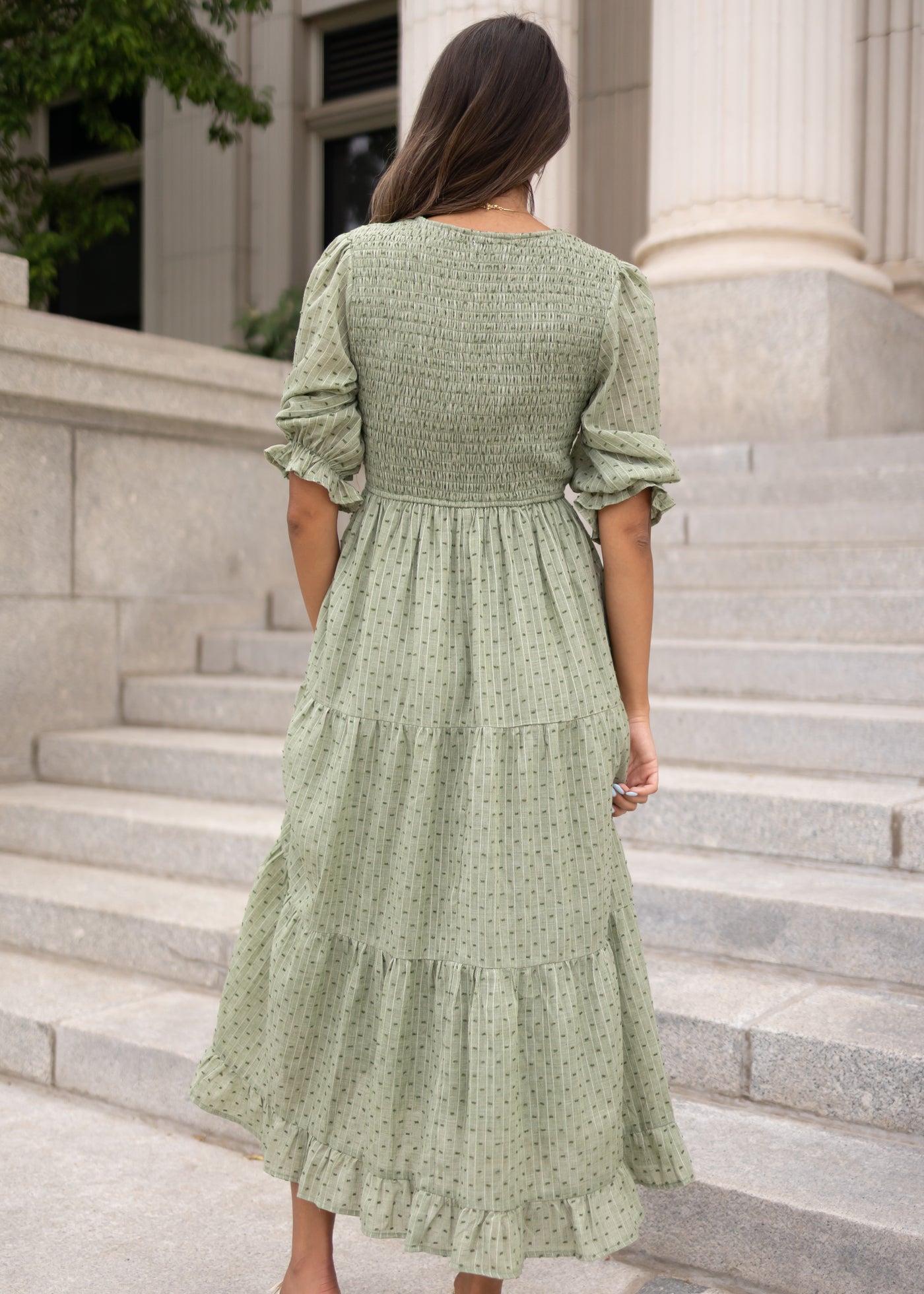 Back view of the modest green smocked dress