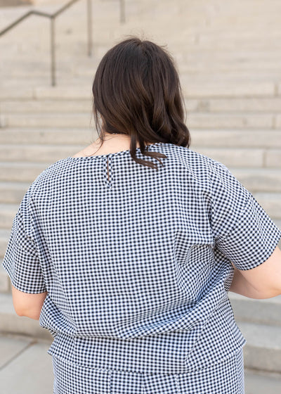 Back view of the plus size black gingham top
