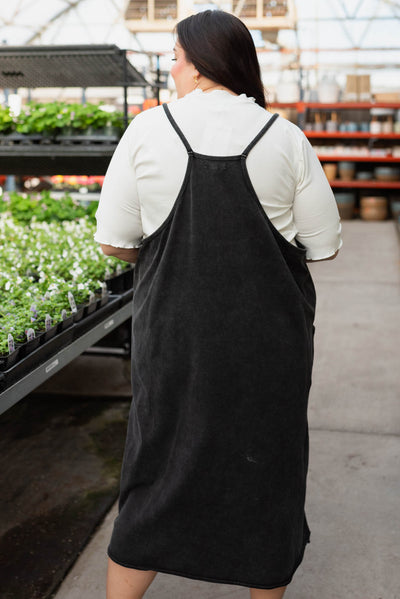 Back view of the plus size black washed jumper dress