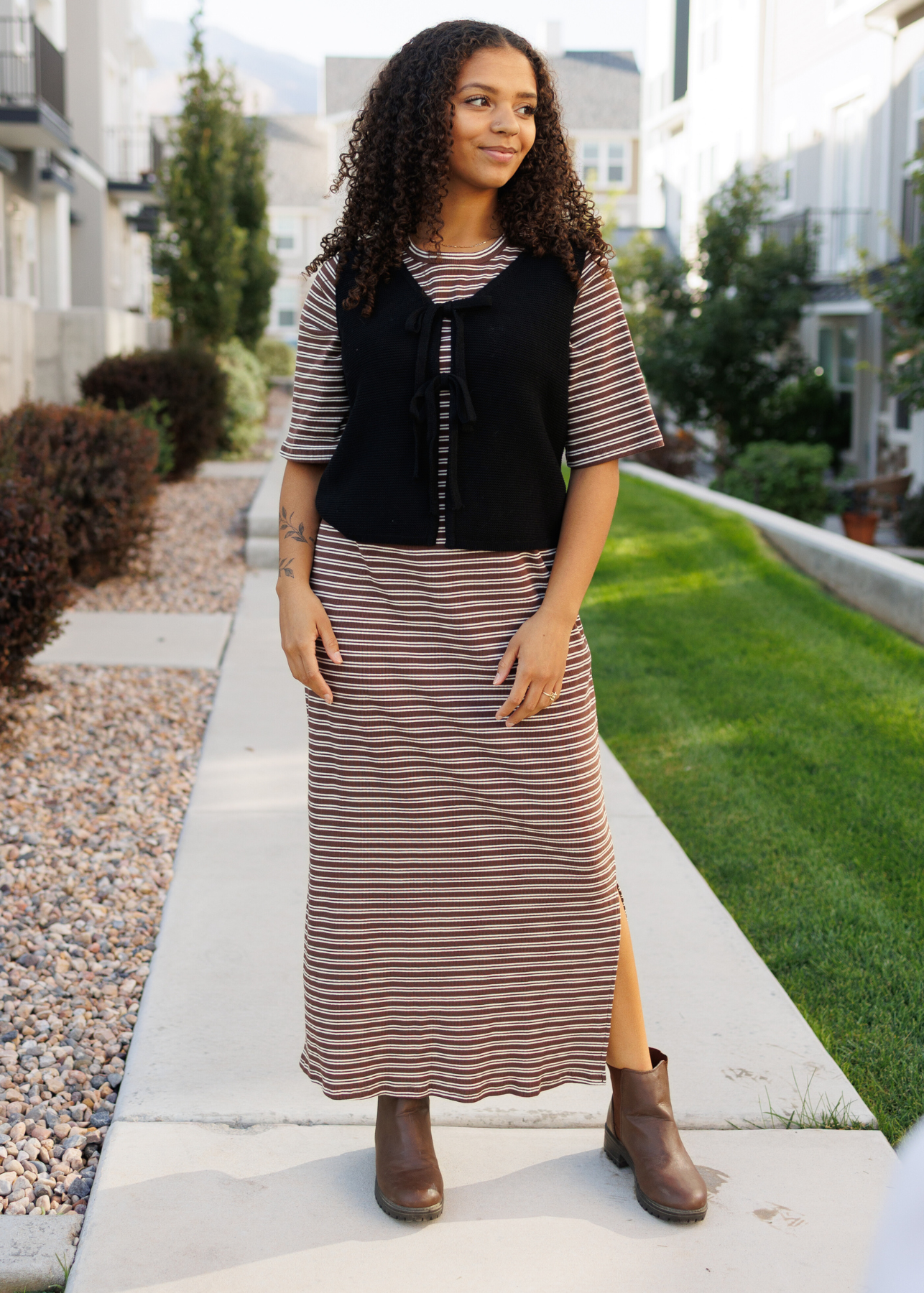 Slits in the sides of the modest chestnut stripe dress