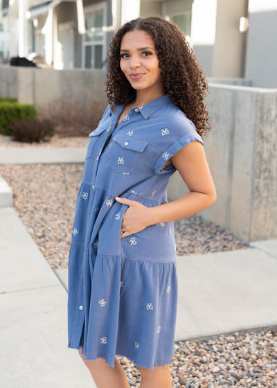 Side view of the denim bow embroidered dress with pockets