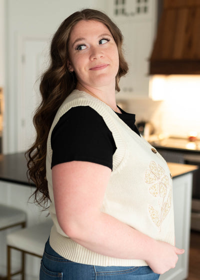 Side view of the plus size flower patch sweater vest
