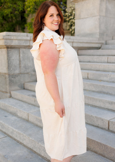 Side view of the natural flutter sleeve dress in plus size