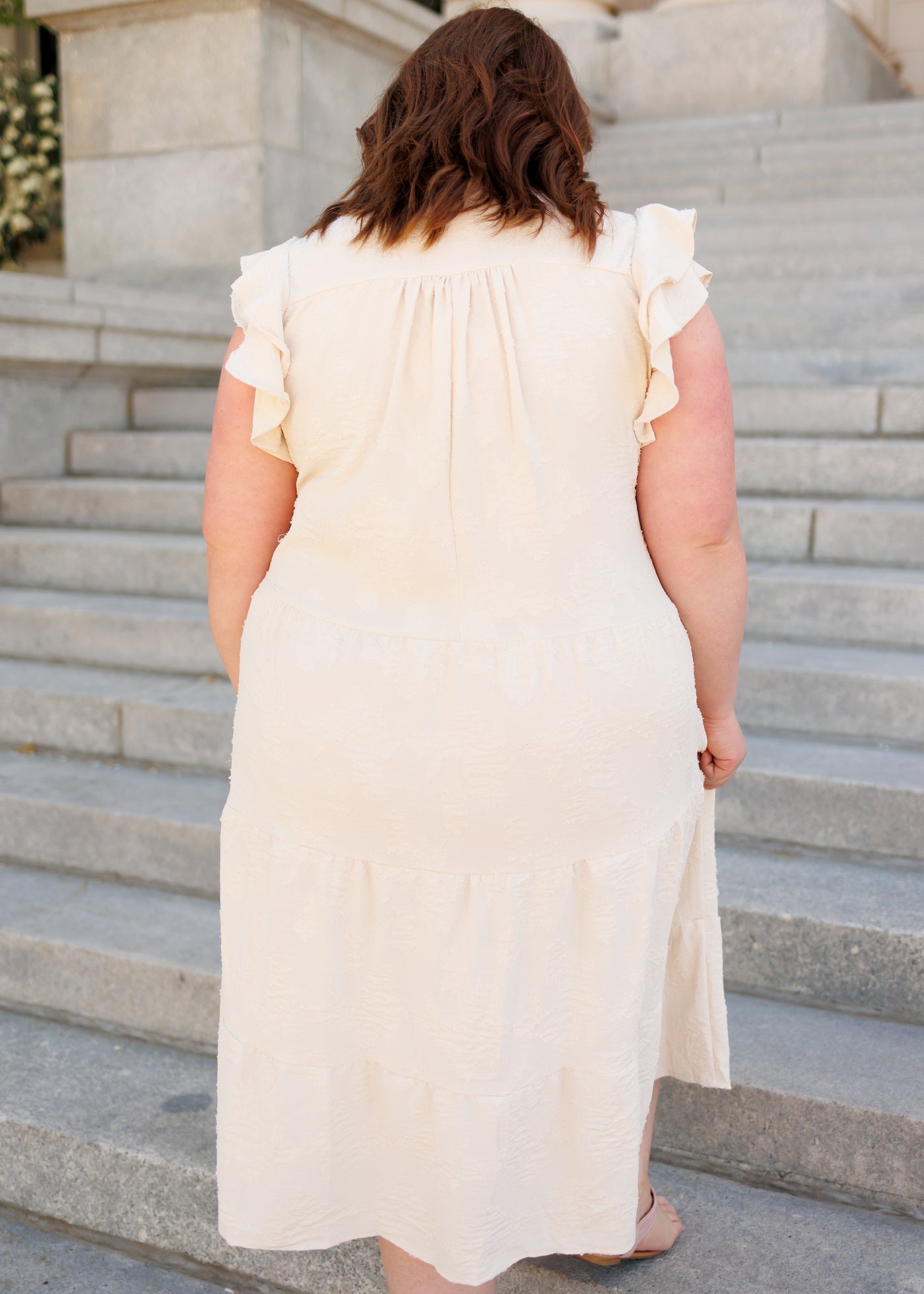 Back view of the plus size natural flutter sleeve dress