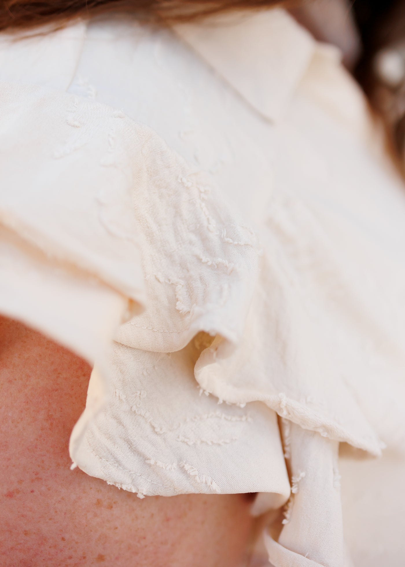 Close up of the ruffle sleeve on the natural flutter sleeve dress