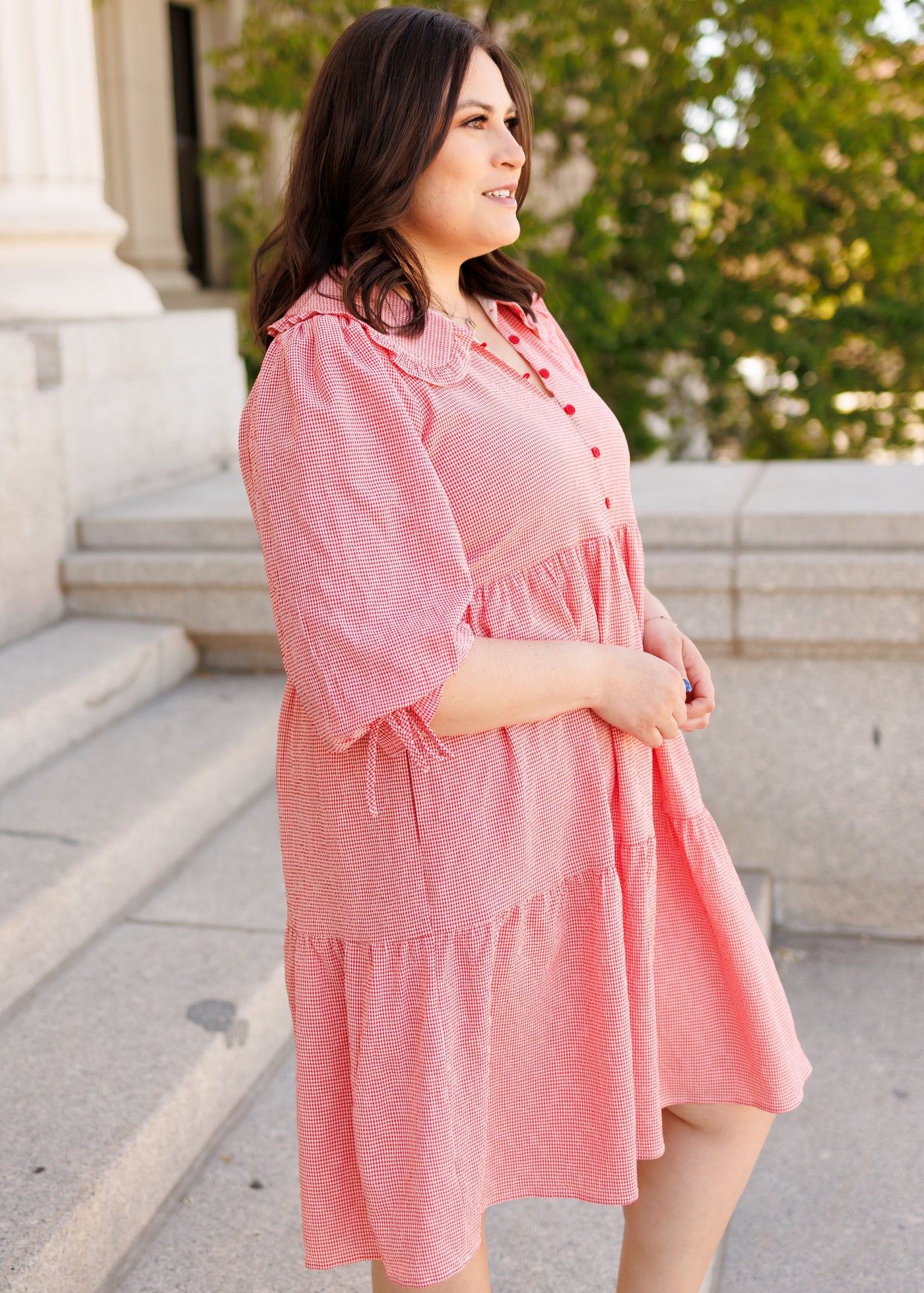 Side view of the red gingham dress in plus size with tiered skirt