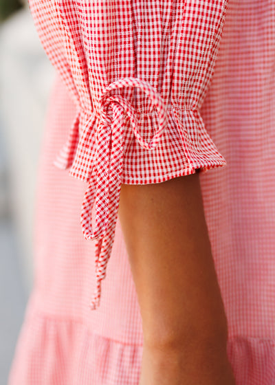 Close up of the cuff and tie on the red gingham dress