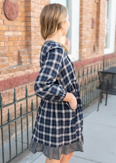 Side view of the navy plaid dress with pockets