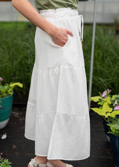 Side view of the white tiered maxi skirt with pockets