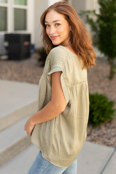 Side view of a light olive top 
