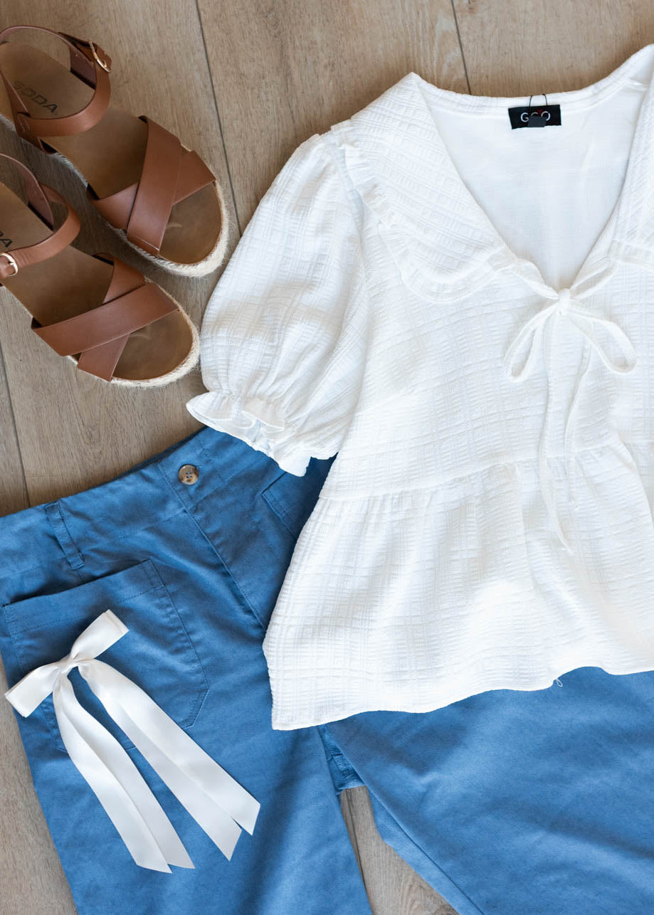 Flat layout of the cropped blue pants