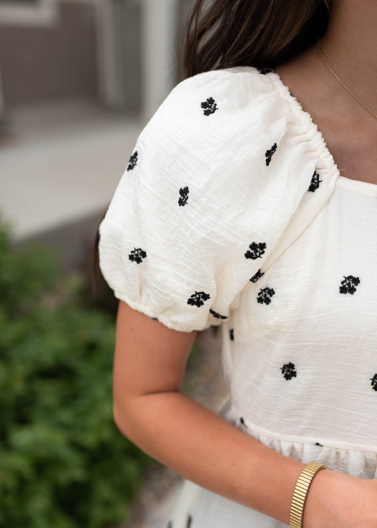 Close up of the sleeve and fabric on the ivory floral embroidered dress