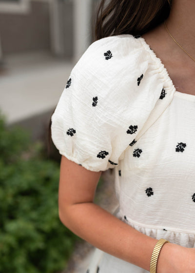 Close up of the sleeve and fabric on the ivory floral embroidered dress