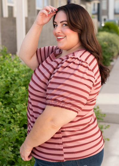 Side view of the pink and burgundy striped top in plus size