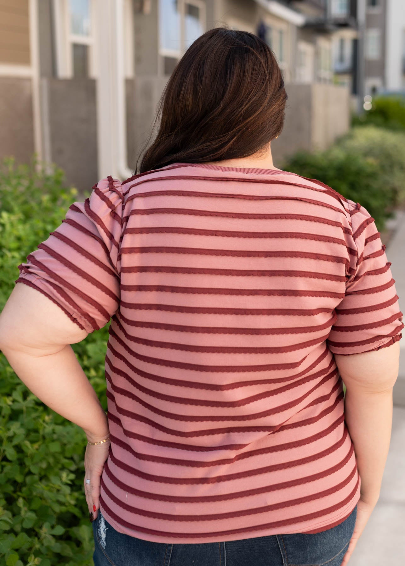 Back view of the pink and burgundy striped top in plus size