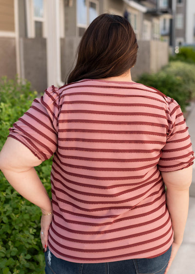 Back view of the pink and burgundy striped top in plus size