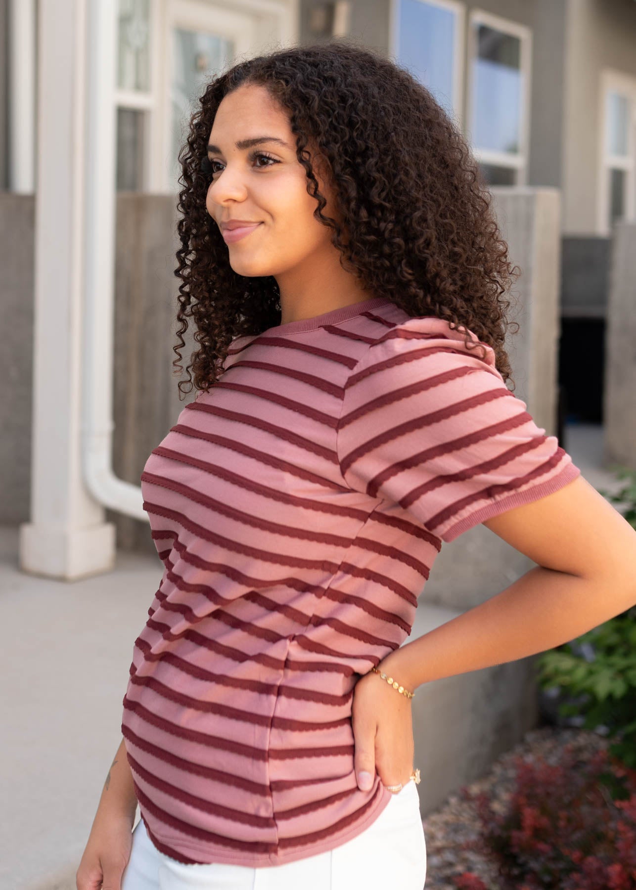 Side view of the pink and burgundy striped top