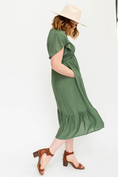 short sleeve buttercream dress with a V-neck and smocked bodice.