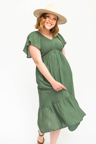 Buttercream dress with a V-neck and smocked bodice.