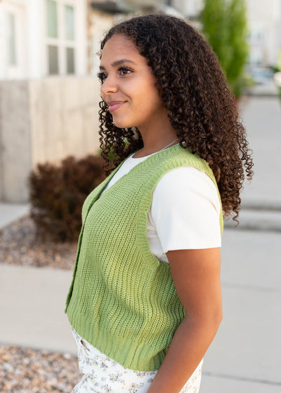 Side view of the green button up vest