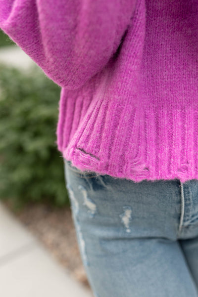 Close up of the hem on a orchid sweater