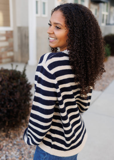 Side view of the navy striped pattern sweater