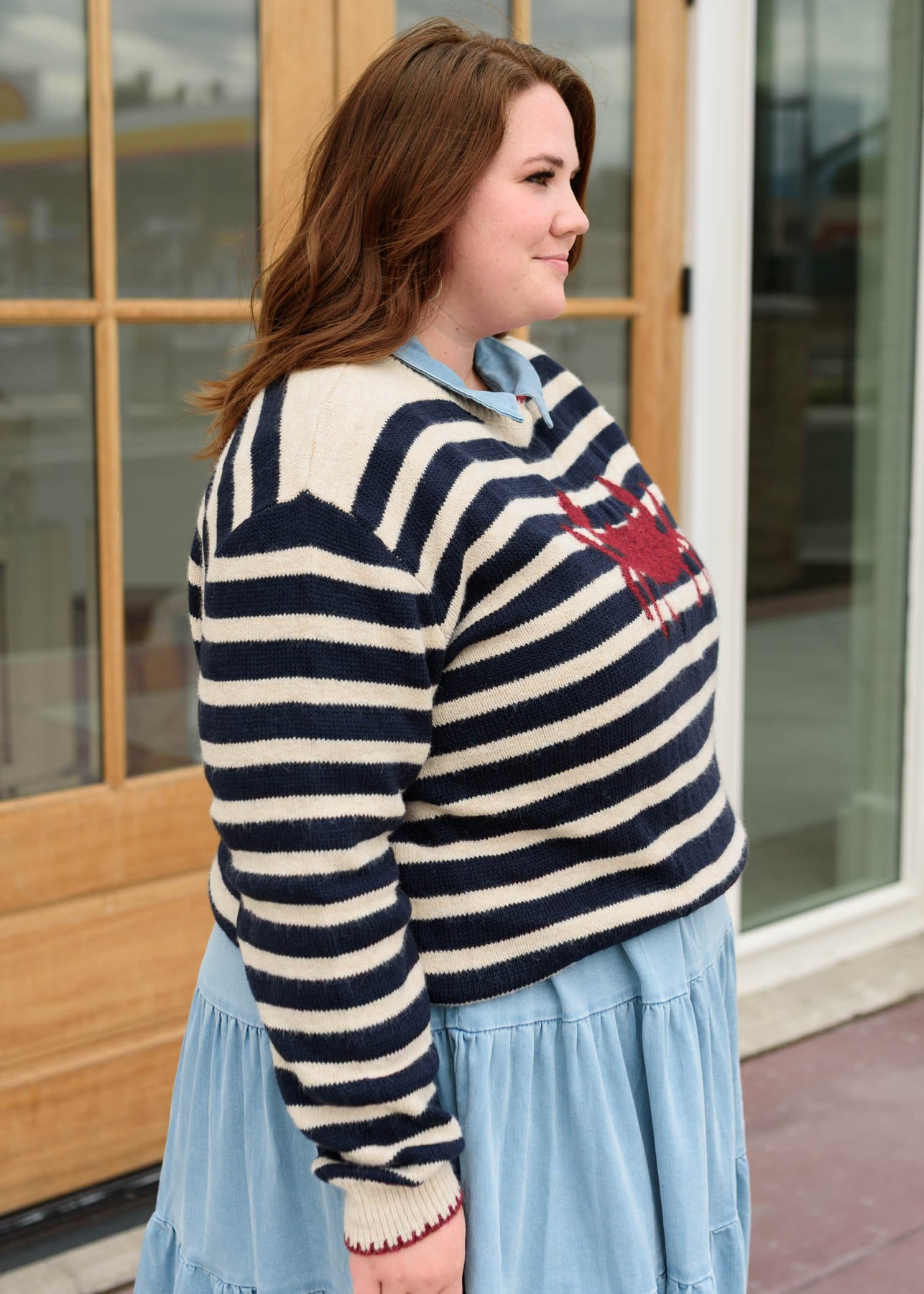 Side view of the red crab striped pattern sweater