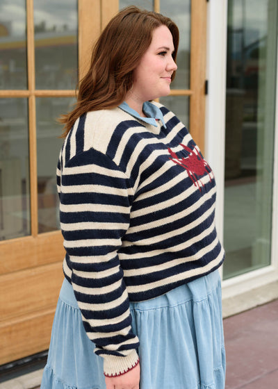 Side view of the red crab striped pattern sweater