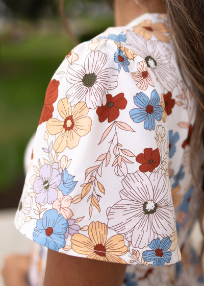 Close up of the sleeve on the modest cream floral dress by lena lou
