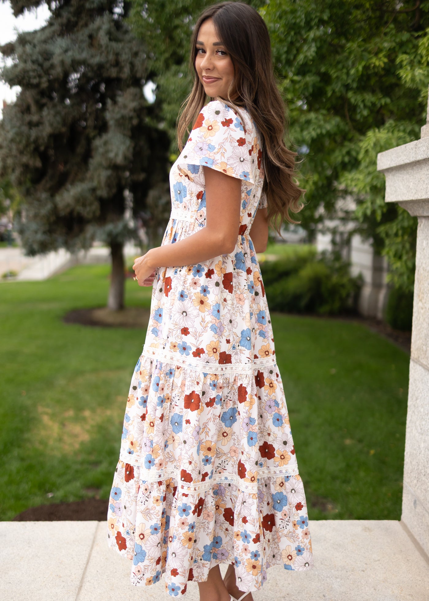 Side view of the lena lou exclusive cream floral dress