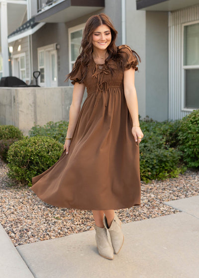 Bows on the bodice and neck on the cocoa smocked dress