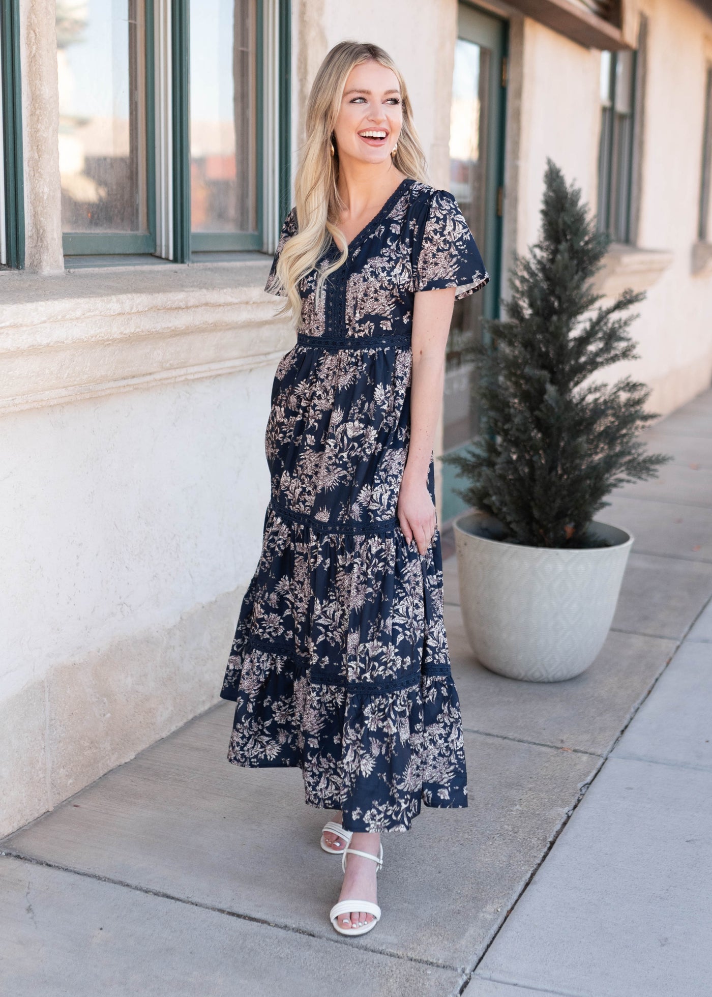 White and pink flowers on the navy blue patterned dress