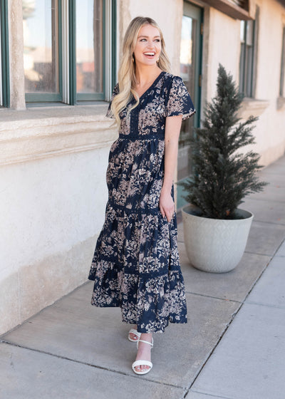 White and pink flowers on the navy blue patterned dress