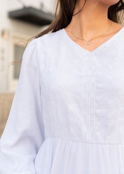 Close up of the white embroidered bodice dress