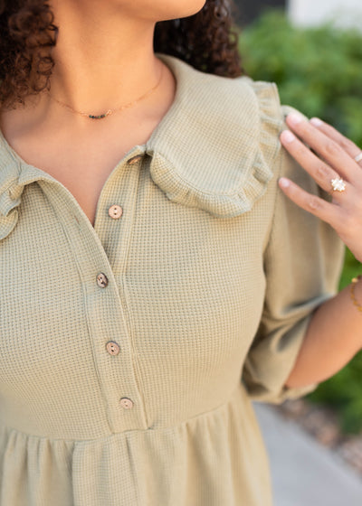 Dusty sage collar dress with round collar and ruffle.