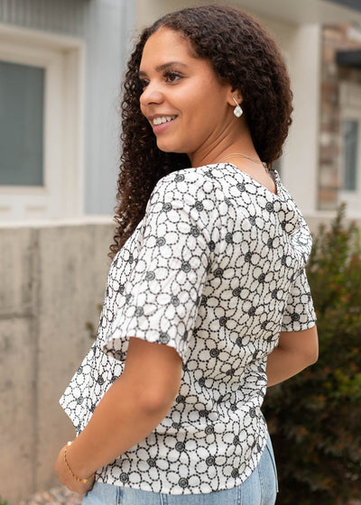 Side view of the black floral embroidered shirt