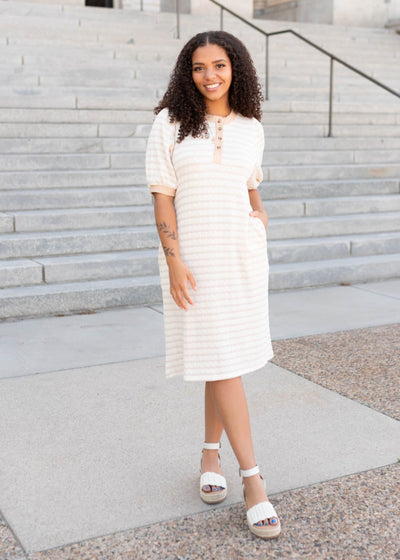 Beige striped dress with buttons on the bodice