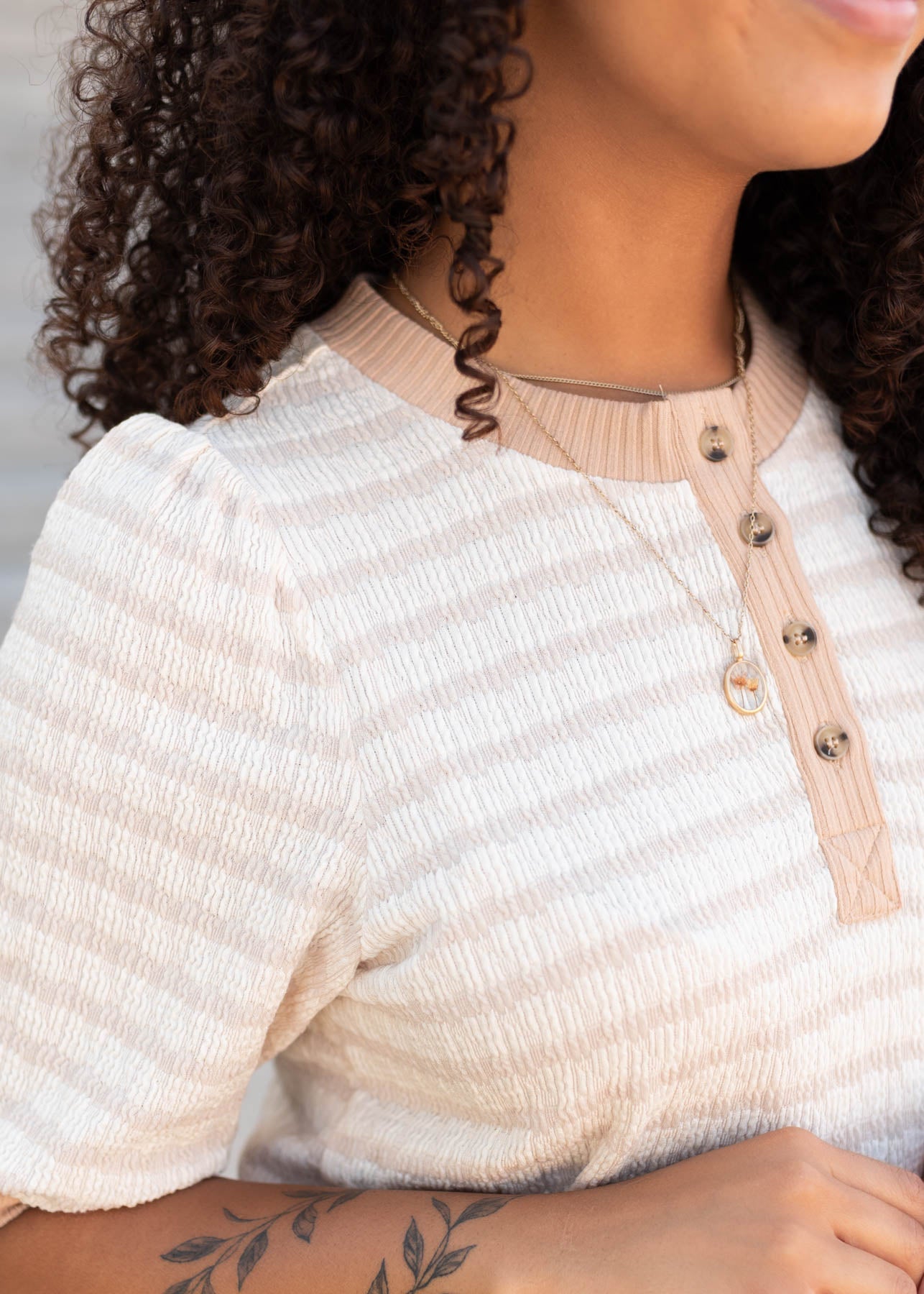 Close up of the fabric on the beige striped dress