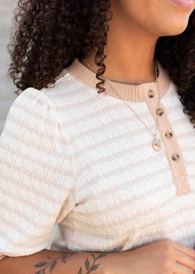 Close up of the fabric on the beige striped dress