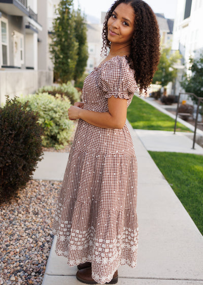 Side view of the ivory embroidery brown gingham dress