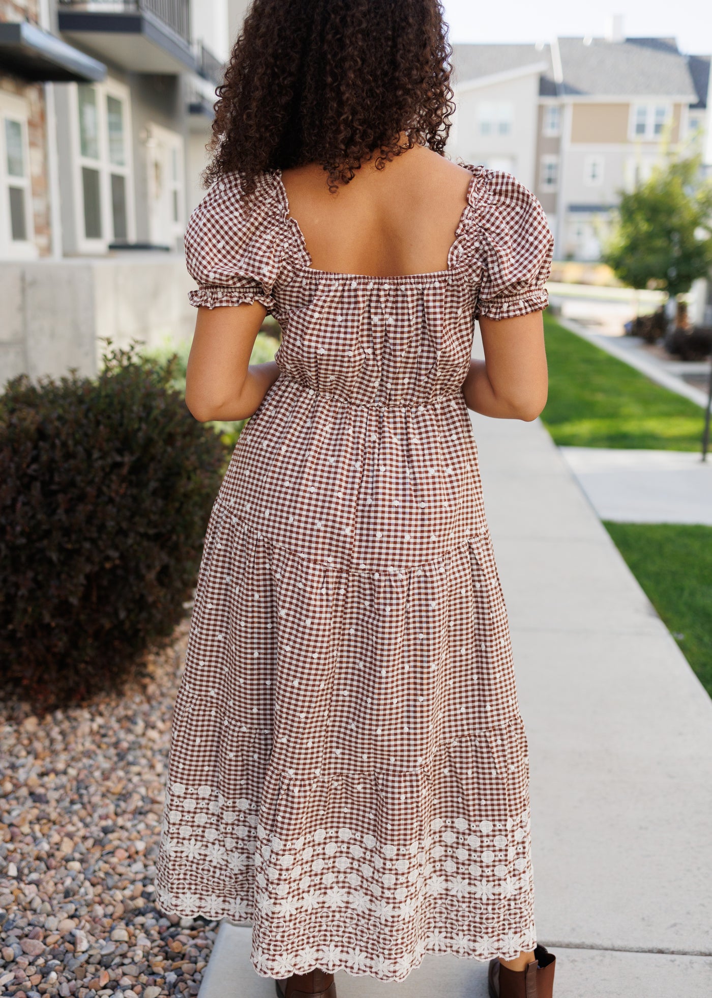 Back view of the brown gingham dress with ivory embroidery