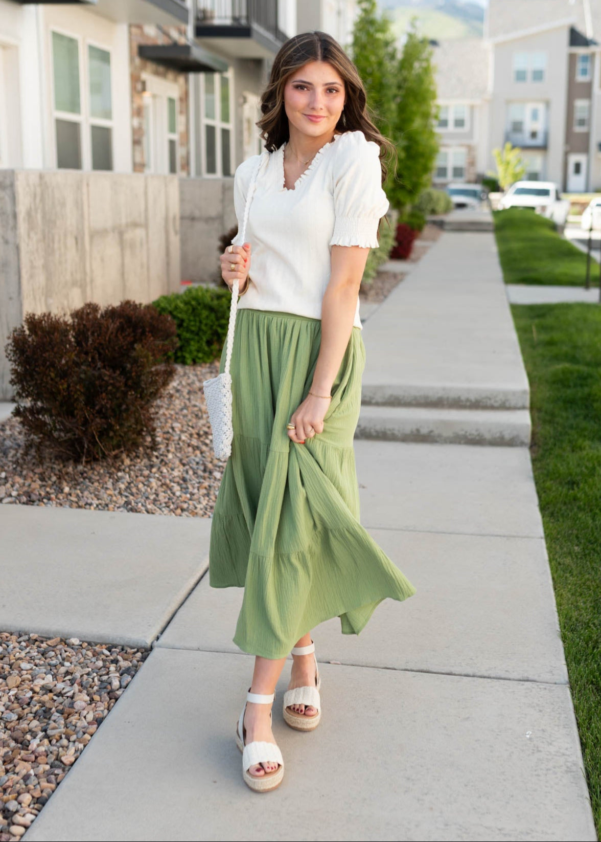 Ivory top with ruffle on the neck and cuffs