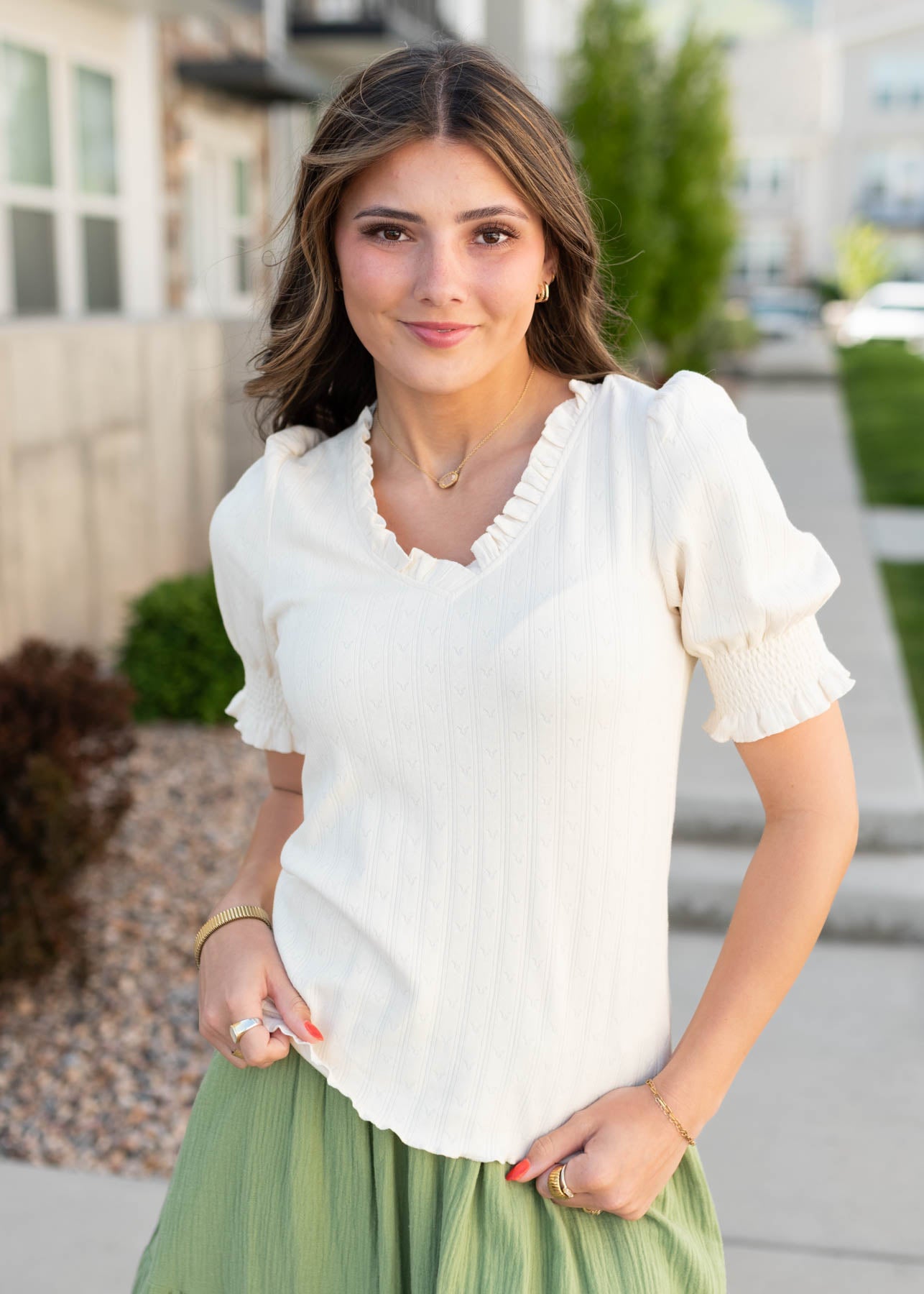 Ivory top with a ruffle on the v-neck