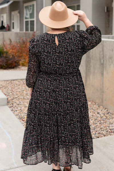 Back view of a plus size black floral dress