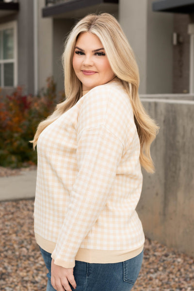 Side view of the plus size ivory sweater
