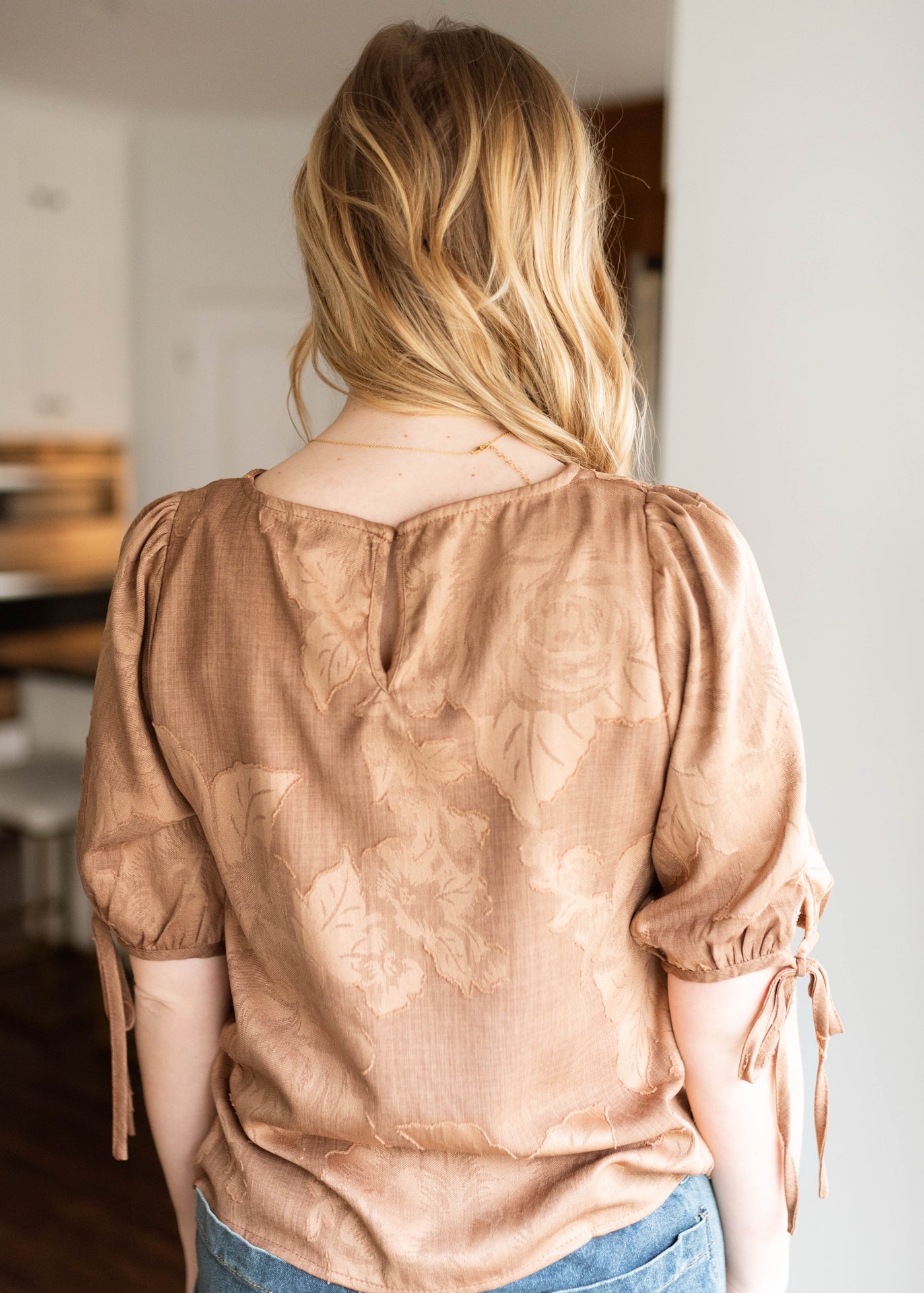 Back view of the brown floral top