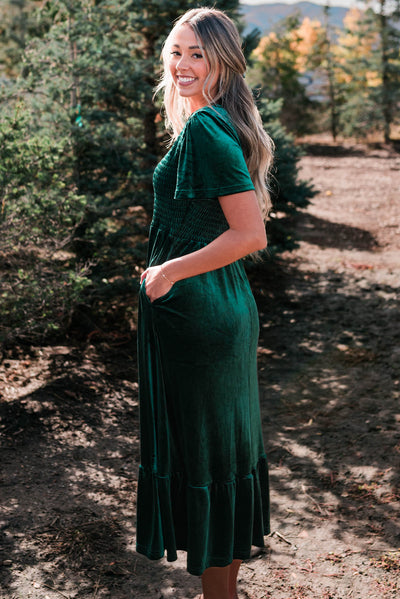 Side view of the evergreen velvet maxi dress