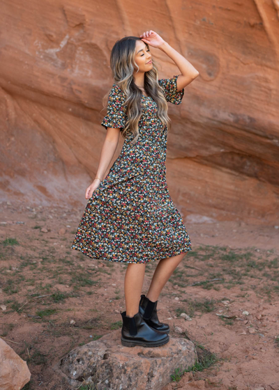 Side view of a short sleeve black floral dress